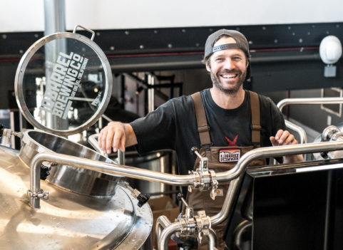 man smiling while working at brewery
